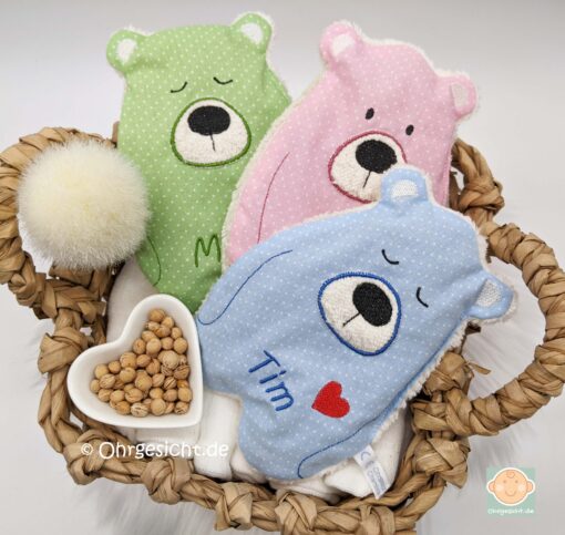 Bunte Körnerkissen mit Teddybärmotiv für Babys.